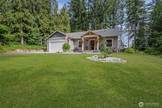 17501 Clearlake Blvd SE, Yelm, WA 98597 - view of front of home with a garage, a front yard, and driveway