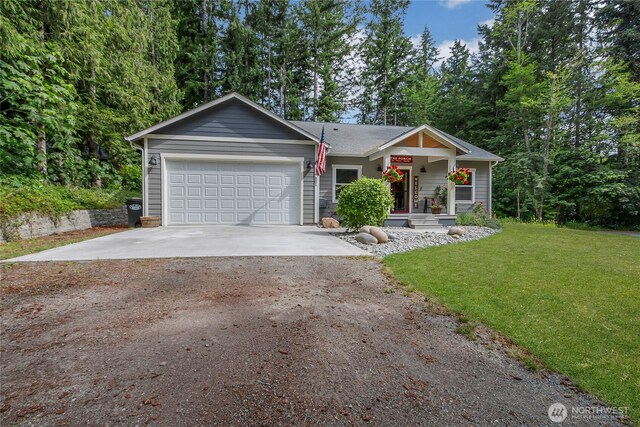 17501 Clearlake Blvd SE, Yelm, WA 98597 - view of front of house featuring driveway, an attached garage, a front yard, and covered porch