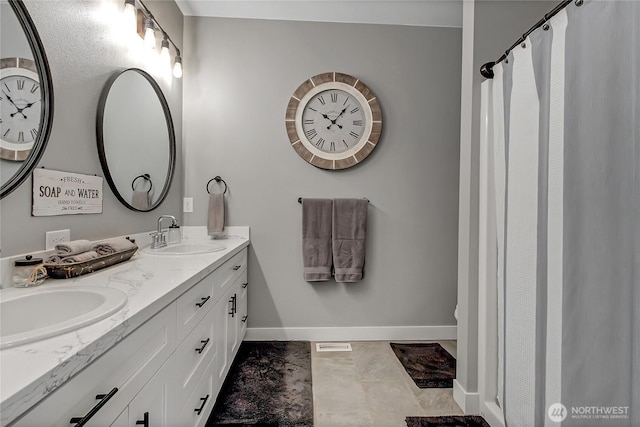 17501 Clearlake Blvd SE, Yelm, WA 98597 - bathroom featuring double vanity and marble look tile flooring