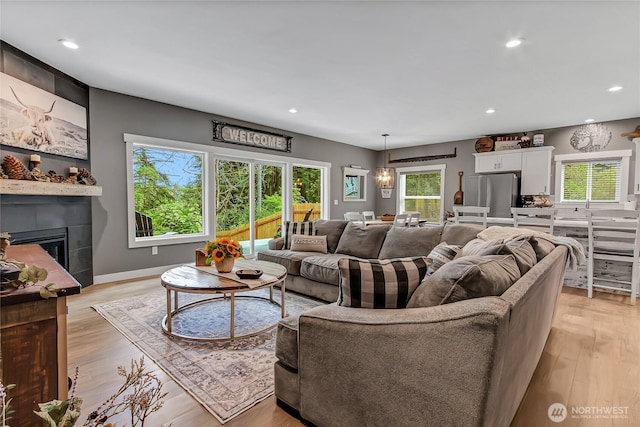 17501 Clearlake Blvd SE, Yelm, WA 98597 - living area featuring recessed lighting, a glass covered fireplace, and light wood-style flooring