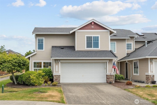 7114 Hazel Pl SE, Auburn, WA 98092 - view of front facade with stone siding, concrete driveway, an attached garage, and a shingled roof