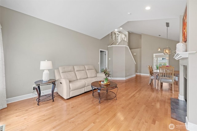 7114 Hazel Pl SE, Auburn, WA 98092 - living area with high vaulted ceiling, light wood-type flooring, recessed lighting, stairway, and a fireplace