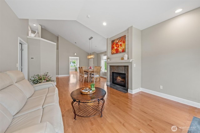 7114 Hazel Pl SE, Auburn, WA 98092 - living area with high vaulted ceiling, light wood finished floors, a tiled fireplace, and recessed lighting