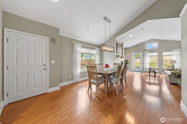 7114 Hazel Pl SE, Auburn, WA 98092 - dining area with lofted ceiling, plenty of natural light, light wood-style floors, and a chandelier