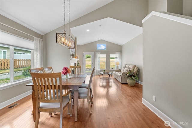 7114 Hazel Pl SE, Auburn, WA 98092 - dining room featuring lofted ceiling, light wood-type flooring, and a chandelier