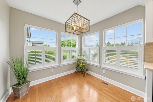 7114 Hazel Pl SE, Auburn, WA 98092 - sunroom / solarium featuring plenty of natural light, hardwood / wood-style flooring, and a chandelier