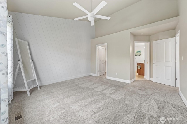 7114 Hazel Pl SE, Auburn, WA 98092 - unfurnished bedroom with carpet floors, a walk in closet, a ceiling fan, a towering ceiling, and ensuite bath