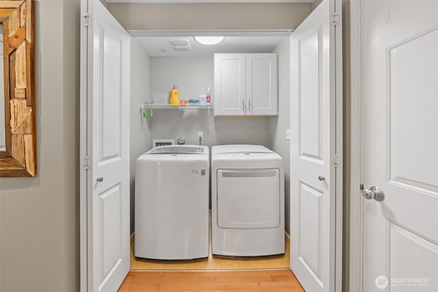 7114 Hazel Pl SE, Auburn, WA 98092 - laundry area featuring cabinet space, separate washer and dryer, and light wood-type flooring