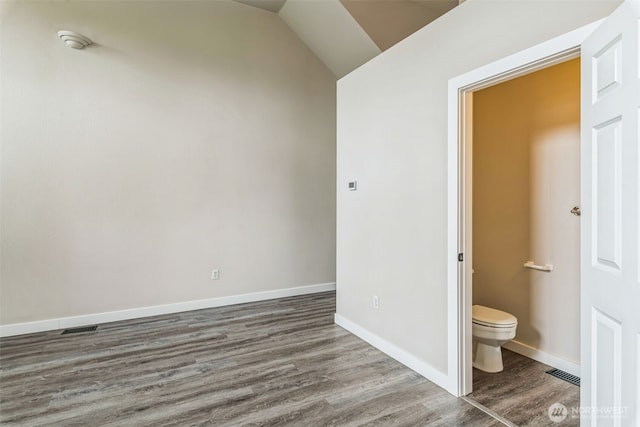 1124 S 23rd St, Tacoma, WA 98405 - bathroom with wood finished floors, toilet, baseboards, and vaulted ceiling