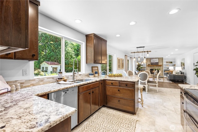 15052 253rd Ave SE, Issaquah, WA 98027 - kitchen featuring appliances with stainless steel finishes, recessed lighting, a peninsula, light stone counters, and decorative backsplash