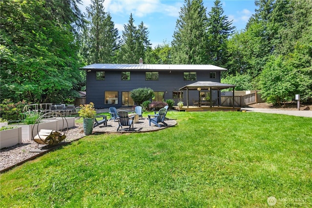 15052 253rd Ave SE, Issaquah, WA 98027 - back of property with a gazebo, a yard, a wooden deck, a fire pit, and a vegetable garden