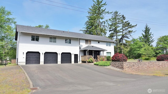 801 Hassalo Ave SE, Ocean Shores, WA 98569 - view of front of home featuring an attached garage and asphalt driveway