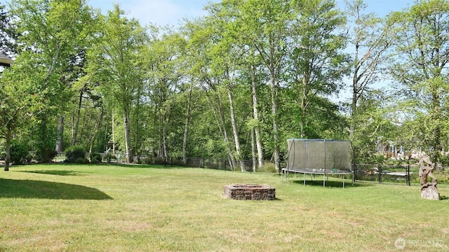 801 Hassalo Ave SE, Ocean Shores, WA 98569 - view of yard featuring a trampoline and a fire pit