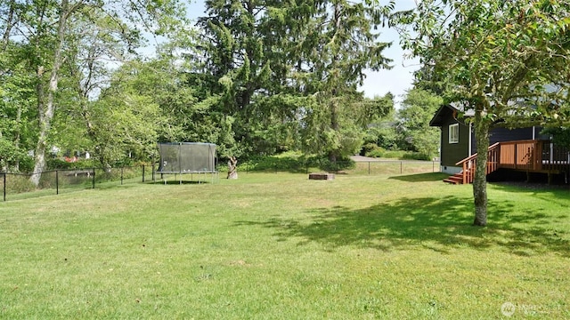 801 Hassalo Ave SE, Ocean Shores, WA 98569 - view of yard featuring a trampoline and a deck