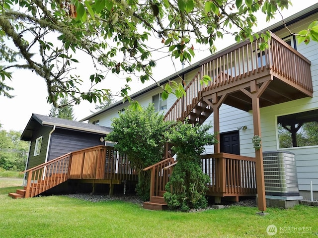 801 Hassalo Ave SE, Ocean Shores, WA 98569 - rear view of house with a deck and a lawn