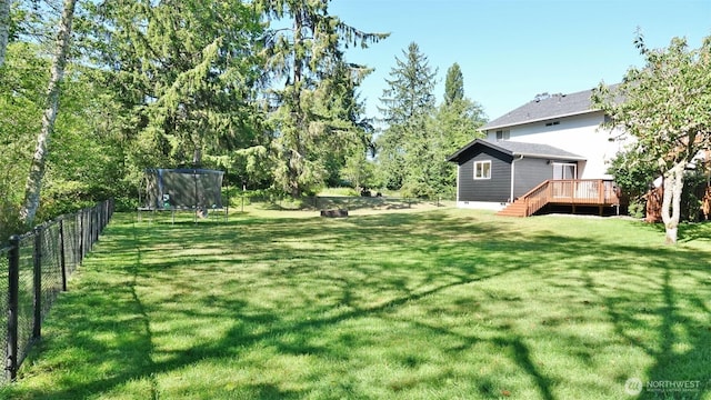801 Hassalo Ave SE, Ocean Shores, WA 98569 - view of yard featuring a trampoline, a wooden deck, and stairs