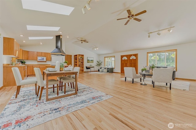 326 Cook Ave, Port Townsend, WA 98638 - dining space with track lighting, ceiling fan, light wood-style floors, and vaulted ceiling
