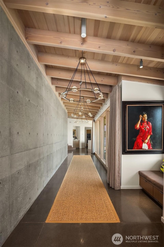 7964 E Mercer Way, Mercer Island, WA 98040 - corridor featuring a chandelier, finished concrete floors, wooden ceiling with exposed beams, and baseboards