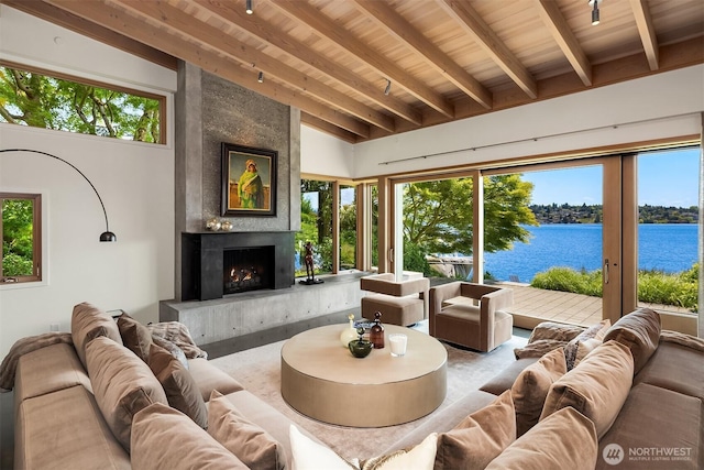 7964 E Mercer Way, Mercer Island, WA 98040 - living area with a water view, wooden ceiling with exposed beams, a large fireplace, and plenty of natural light