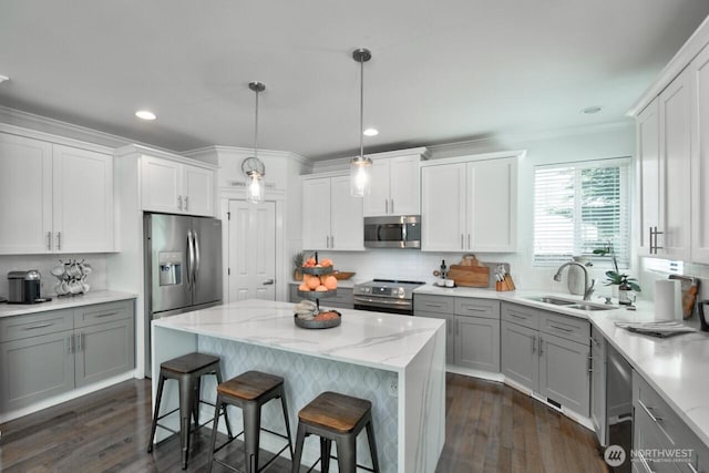 4704 204th Ct E, Spanaway, WA 98387 - kitchen with appliances with stainless steel finishes, gray cabinetry, dark wood finished floors, a kitchen bar, and recessed lighting