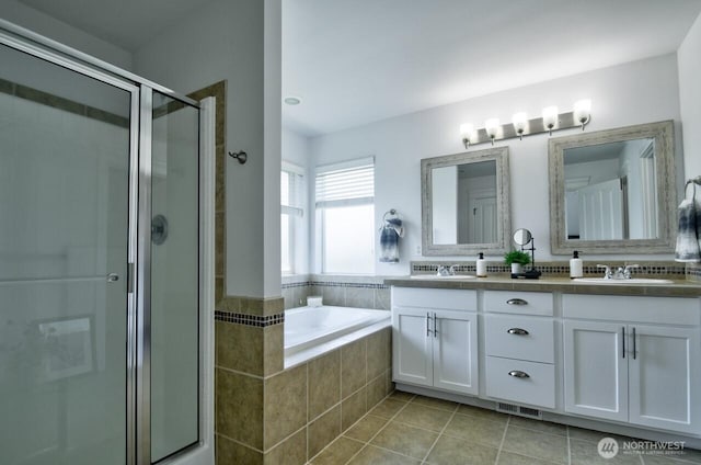 4704 204th Ct E, Spanaway, WA 98387 - full bath with a shower stall, double vanity, tile patterned flooring, and a bath