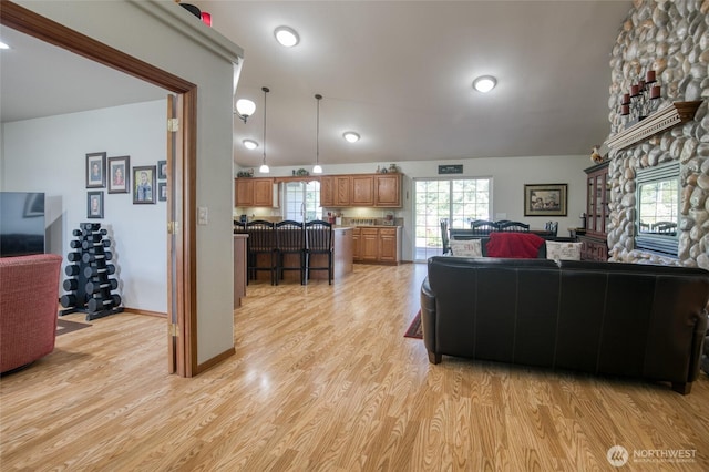 108 Garden Pl, Elma, WA 98541 - living area with lofted ceiling, light wood-style floors, and a stone fireplace