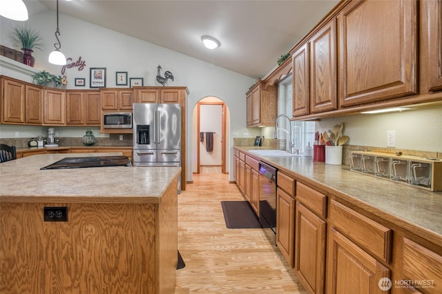 108 Garden Pl, Elma, WA 98541 - kitchen featuring appliances with stainless steel finishes, a sink, arched walkways, light wood-style floors, and brown cabinets