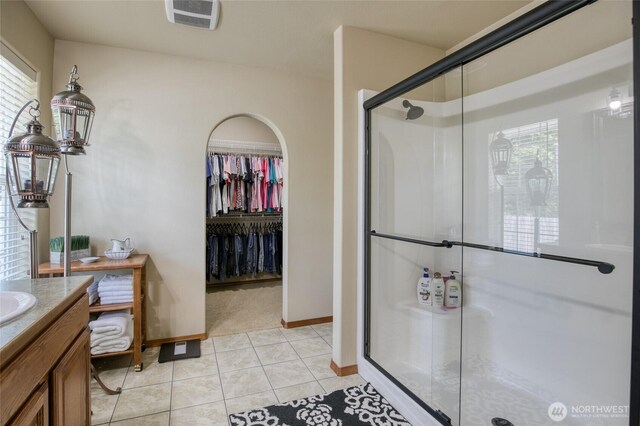 108 Garden Pl, Elma, WA 98541 - bathroom with a stall shower, vanity, tile patterned flooring, baseboards, and a spacious closet