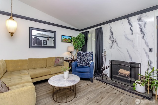 15625 42nd Ave S Unit 8A, Tukwila, WA 98188 - living room featuring vaulted ceiling, wood finished floors, and a high end fireplace