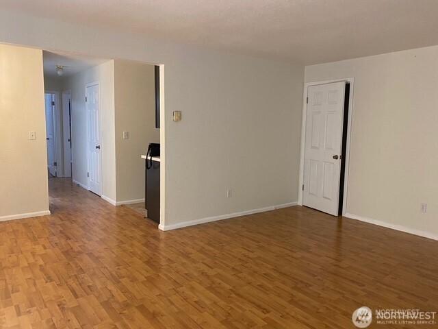 5722 122nd Pl SE Unit 235, Bellevue, WA 98006 - unfurnished room with light wood-style floors and baseboards