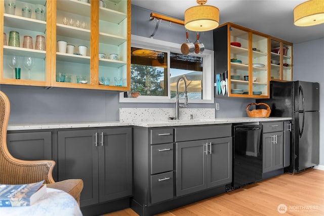 111 Norfolk Rd, Winthrop, WA 98862 - kitchen featuring black appliances, gray cabinets, light wood-style floors, glass insert cabinets, and light stone counters