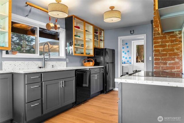 111 Norfolk Rd, Winthrop, WA 98862 - kitchen featuring black appliances, gray cabinetry, light wood finished floors, glass insert cabinets, and light stone countertops