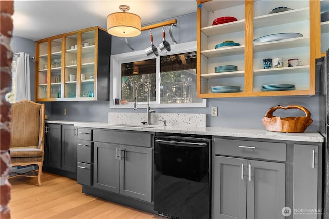 111 Norfolk Rd, Winthrop, WA 98862 - kitchen featuring black dishwasher, gray cabinetry, light stone counters, and light wood finished floors