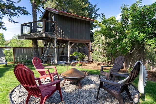 111 Norfolk Rd, Winthrop, WA 98862 - rear view of house with an outdoor fire pit, a fenced backyard, and a balcony