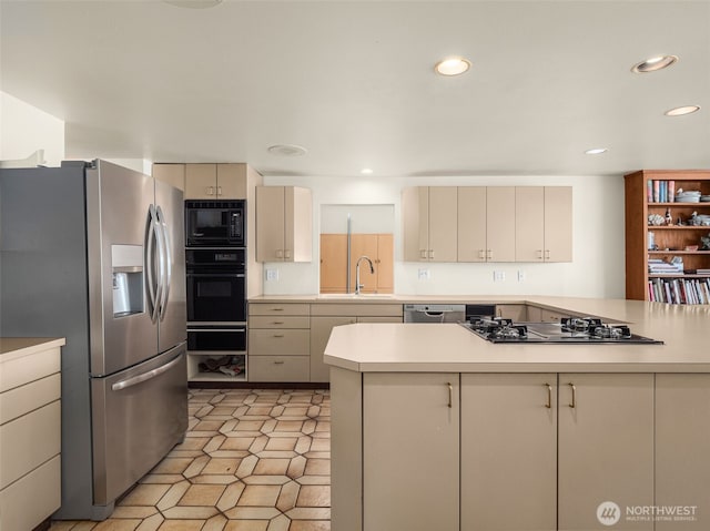 2900 Westlake Ave N, Seattle, WA 98109 - kitchen with black appliances, a warming drawer, light countertops, a sink, and cream cabinetry