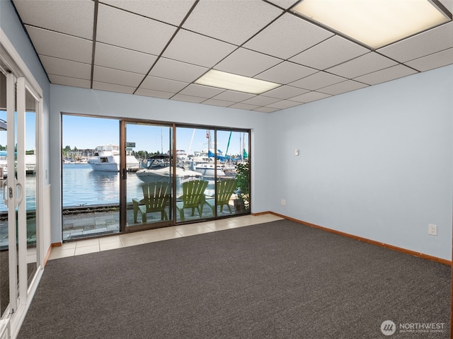 2900 Westlake Ave N, Seattle, WA 98109 - carpeted empty room featuring a water view, a drop ceiling, and baseboards