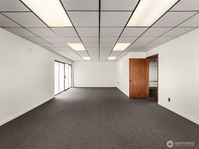 2900 Westlake Ave N, Seattle, WA 98109 - spare room featuring a paneled ceiling, dark colored carpet, and baseboards