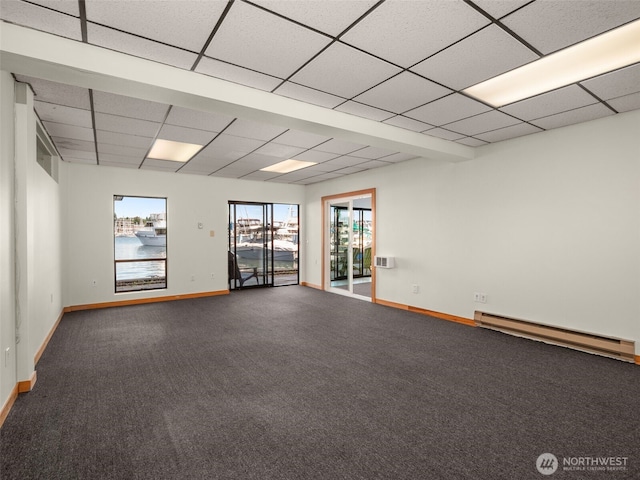 2900 Westlake Ave N, Seattle, WA 98109 - carpeted spare room featuring baseboard heating, baseboards, and a paneled ceiling