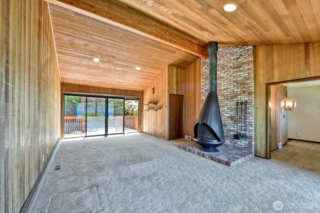 2781 Lake Whatcom Blvd, Bellingham, WA 98229 - unfurnished living room with a wood stove, wood ceiling, carpet, wood walls, and recessed lighting