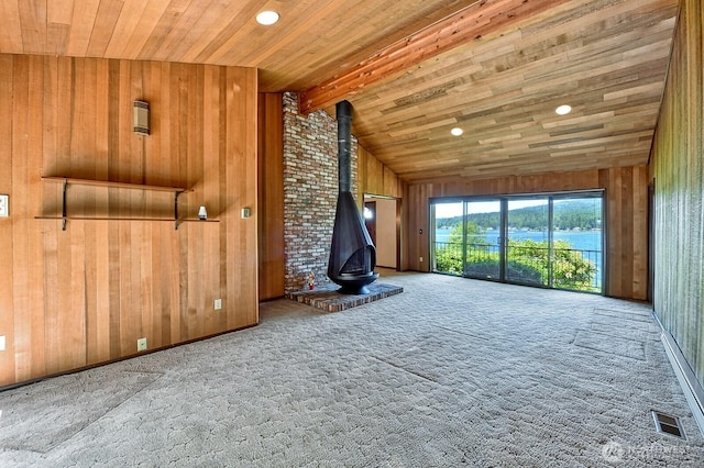2781 Lake Whatcom Blvd, Bellingham, WA 98229 - unfurnished living room featuring wood walls, a wood stove, carpet flooring, wooden ceiling, and recessed lighting