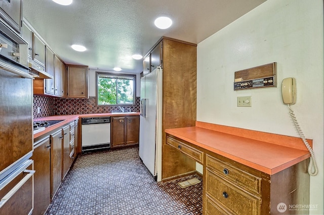 2781 Lake Whatcom Blvd, Bellingham, WA 98229 - kitchen with white appliances, decorative backsplash, a warming drawer, brown cabinets, and a textured ceiling