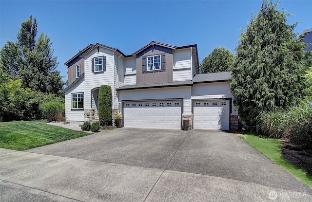 15202 NE 102nd Way, Vancouver, WA 98685 - view of front of house featuring an attached garage, stone siding, concrete driveway, and a front yard