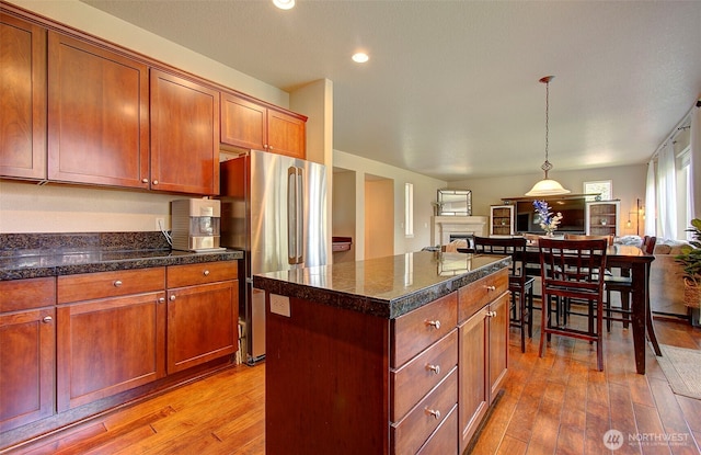 15202 NE 102nd Way, Vancouver, WA 98685 - kitchen featuring open floor plan, freestanding refrigerator, light wood finished floors, a kitchen island, and hanging light fixtures