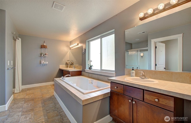 15202 NE 102nd Way, Vancouver, WA 98685 - bathroom with a shower stall, vanity, a garden tub, and stone finish floors