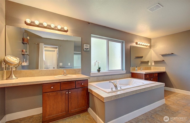 15202 NE 102nd Way, Vancouver, WA 98685 - bathroom featuring a garden tub, two vanities, and a textured ceiling