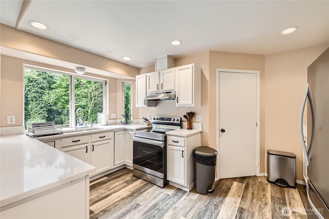7547 NE 200 NE, Kenmore, WA 98028 - kitchen with appliances with stainless steel finishes, under cabinet range hood, a sink, light countertops, and recessed lighting