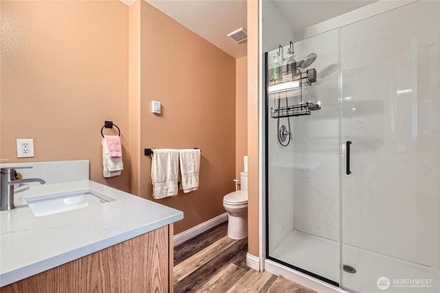 7547 NE 200 NE, Kenmore, WA 98028 - full bathroom featuring wood finished floors, a marble finish shower, toilet, vanity, and baseboards