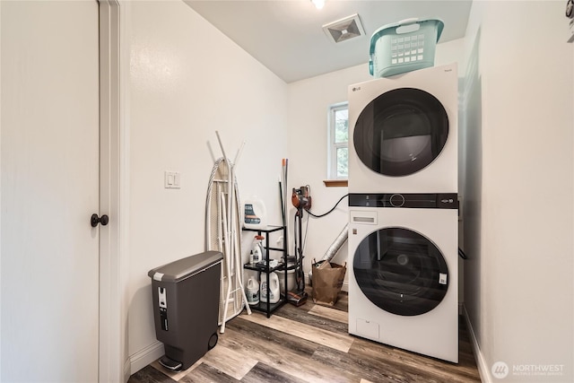 7547 NE 200 NE, Kenmore, WA 98028 - laundry room with estacked washer and dryer and wood finished floors