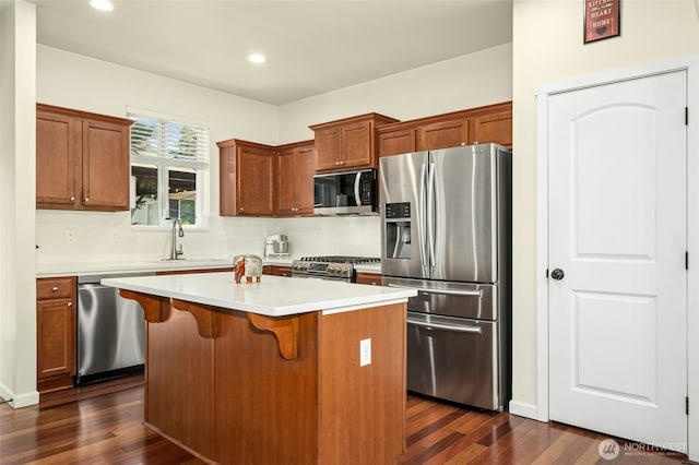 4915 NE 5th St, Renton, WA 98059 - kitchen with appliances with stainless steel finishes, dark wood-style floors, a center island, a kitchen breakfast bar, and recessed lighting