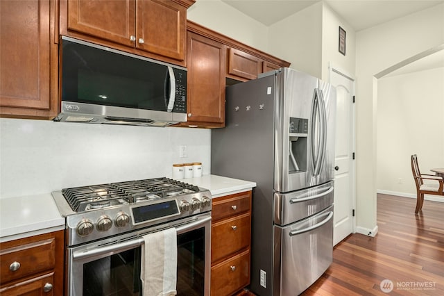 4915 NE 5th St, Renton, WA 98059 - kitchen featuring appliances with stainless steel finishes, dark wood-style floors, light countertops, and brown cabinetry